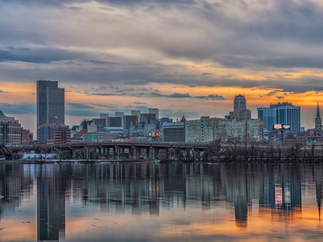 A modern waterfront skyline at sunset
